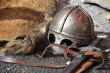 black steel helmet near black and gray handle sword